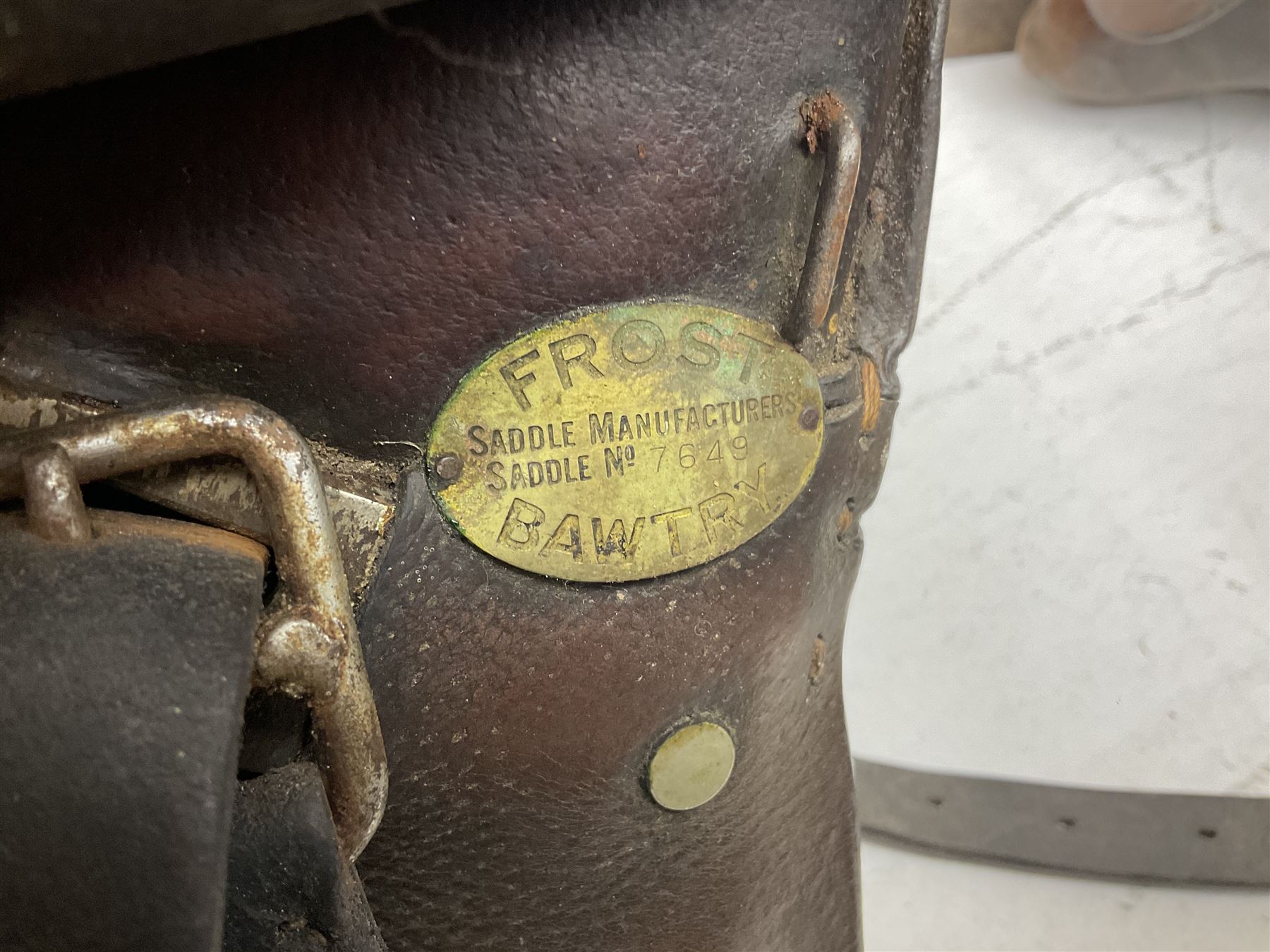 Collection of nine saddles, mainly havana leather to include a racing saddle and a Goodwin saddle, some with stirrups and leathers 
