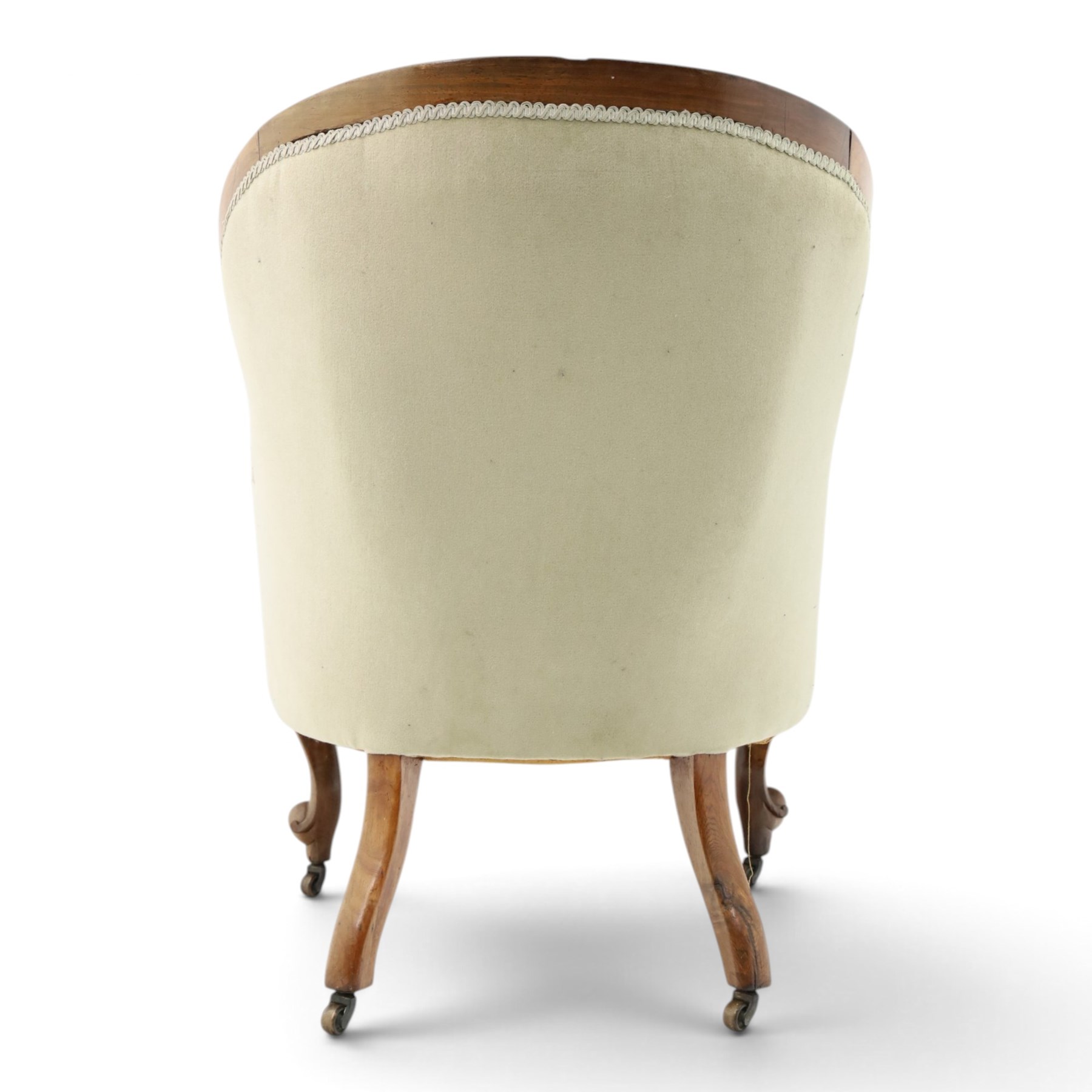 Victorian carved walnut framed armchair with matching stool, the tub-shaped chair with moulded and shaped frame and arm terminals, raised on scrolled cartouche carved supports with scroll feet and castors, buttoned back and sprung seat upholstered in sage green fabric; the small circular footstool with buttoned seat and scroll supports (W36cm H15cm)