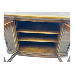 Contemporary cherry wood corner TV unit, canted top over central glazed double doors opening to shelves for media storage, flanked by side storage compartments, on a plinth base