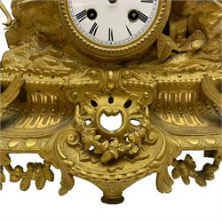 French - late 19th century 8-day gilt spelter mantle clock retailed by J Vassalli of Scarborough c1890, sculptured with an oriental 16th century representation a Mughal warrior slaying a leopard, raised on a profusely  decorated base with scroll work and splayed feet, white enamel dial with Roman numerals, minute track and steel hands, Parisian twin train countwheel striking movement, striking the hours and half-hours on a bell. With pendulum & Key.  