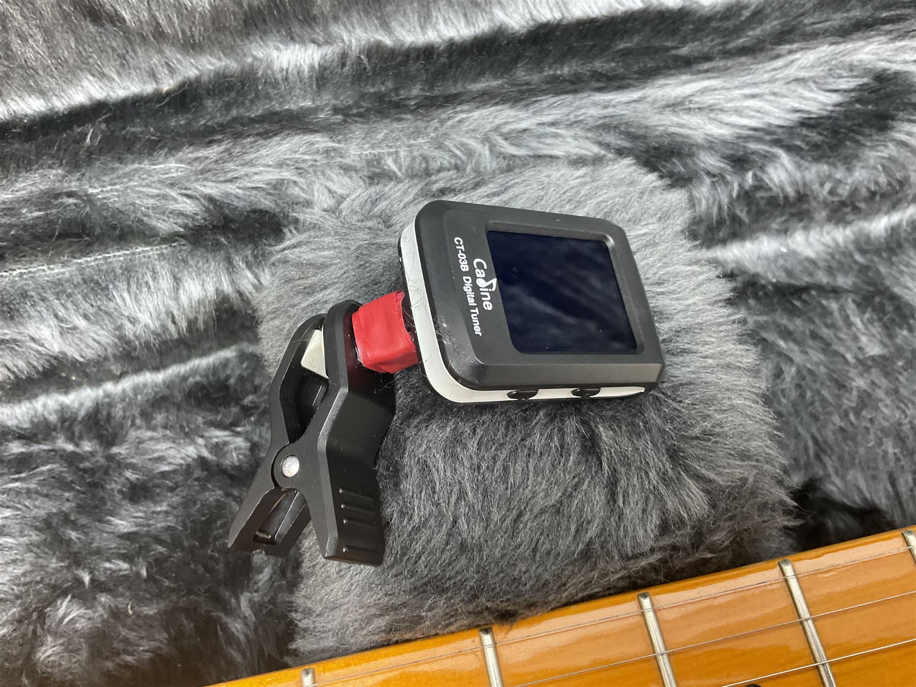Copy of a Fender Stratocaster electric guitar in black with Wilkinson bridge, lock-in tuners, synchronised tremolo and various patent numbers; L99cm; in hard carrying case with strap and digital tuner
