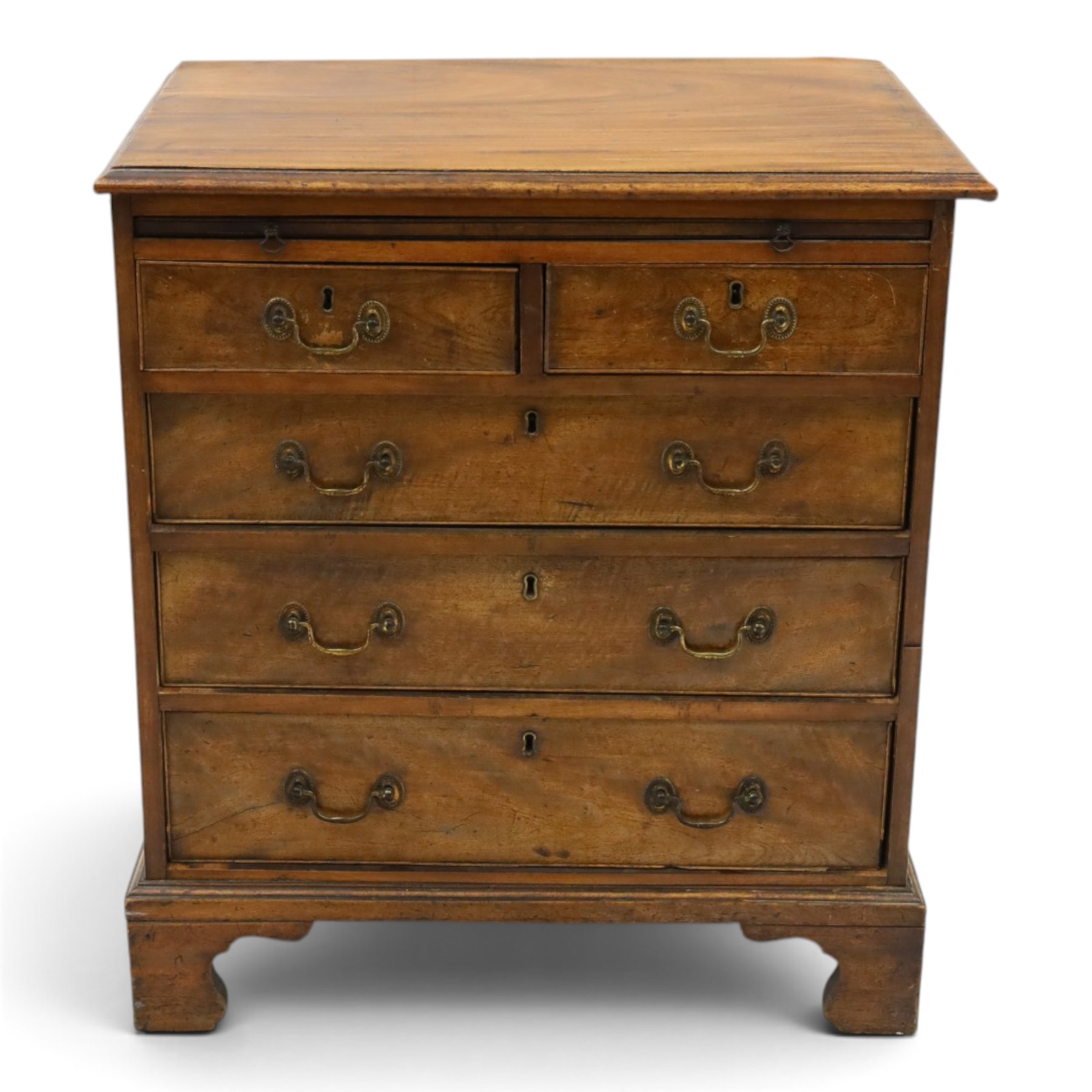 George III mahogany bachelors chest, rectangular top with moulded edge, fitted with brushing slide over two short and three long cock-beaded drawers with brass swan-neck handles, lower moulded edge on bracket feet