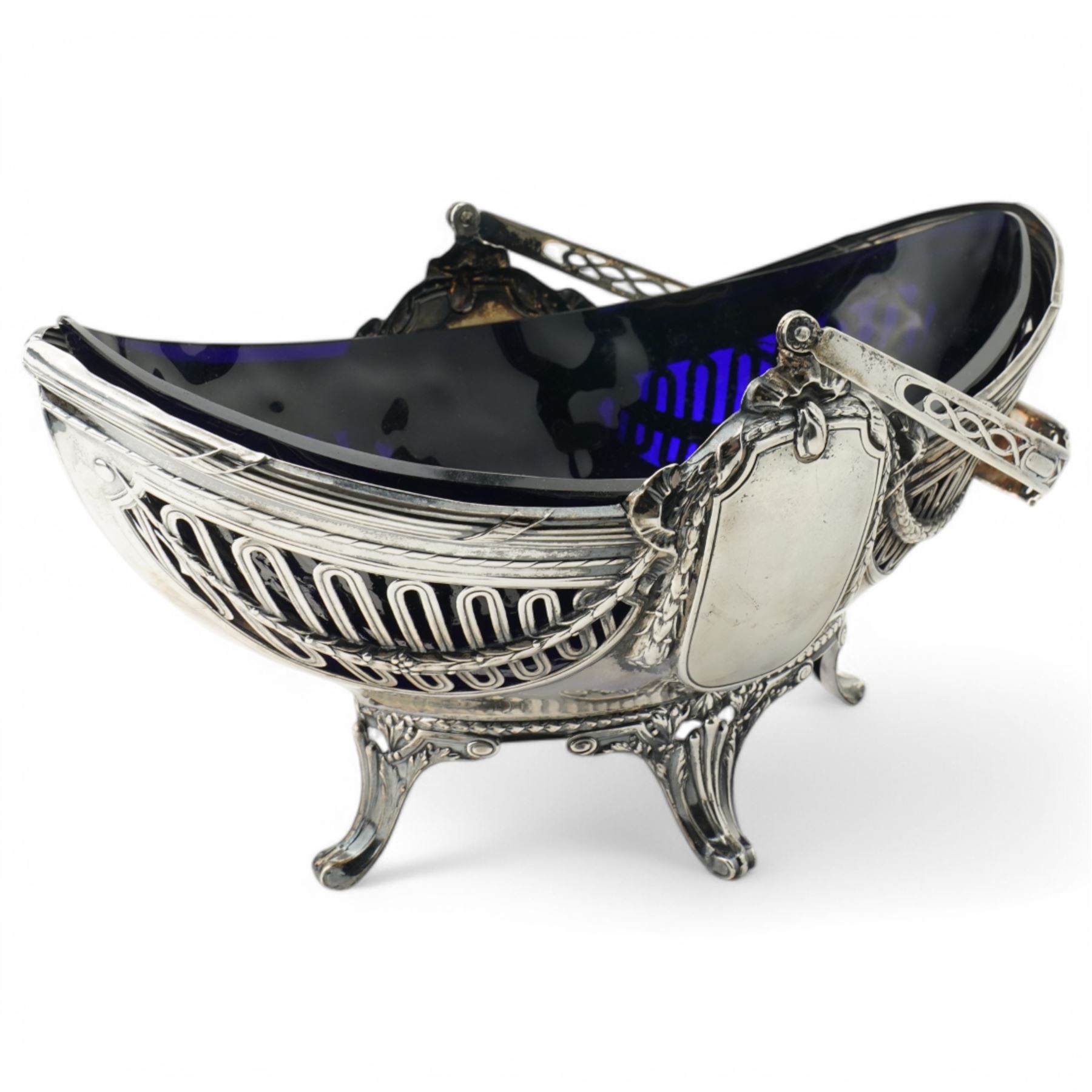 German standard 800 silver oval centrepiece with pierced sides, trailing harebells and swing handle, blue glass liner on splay feet L29cm Maker Wilhelm Binder