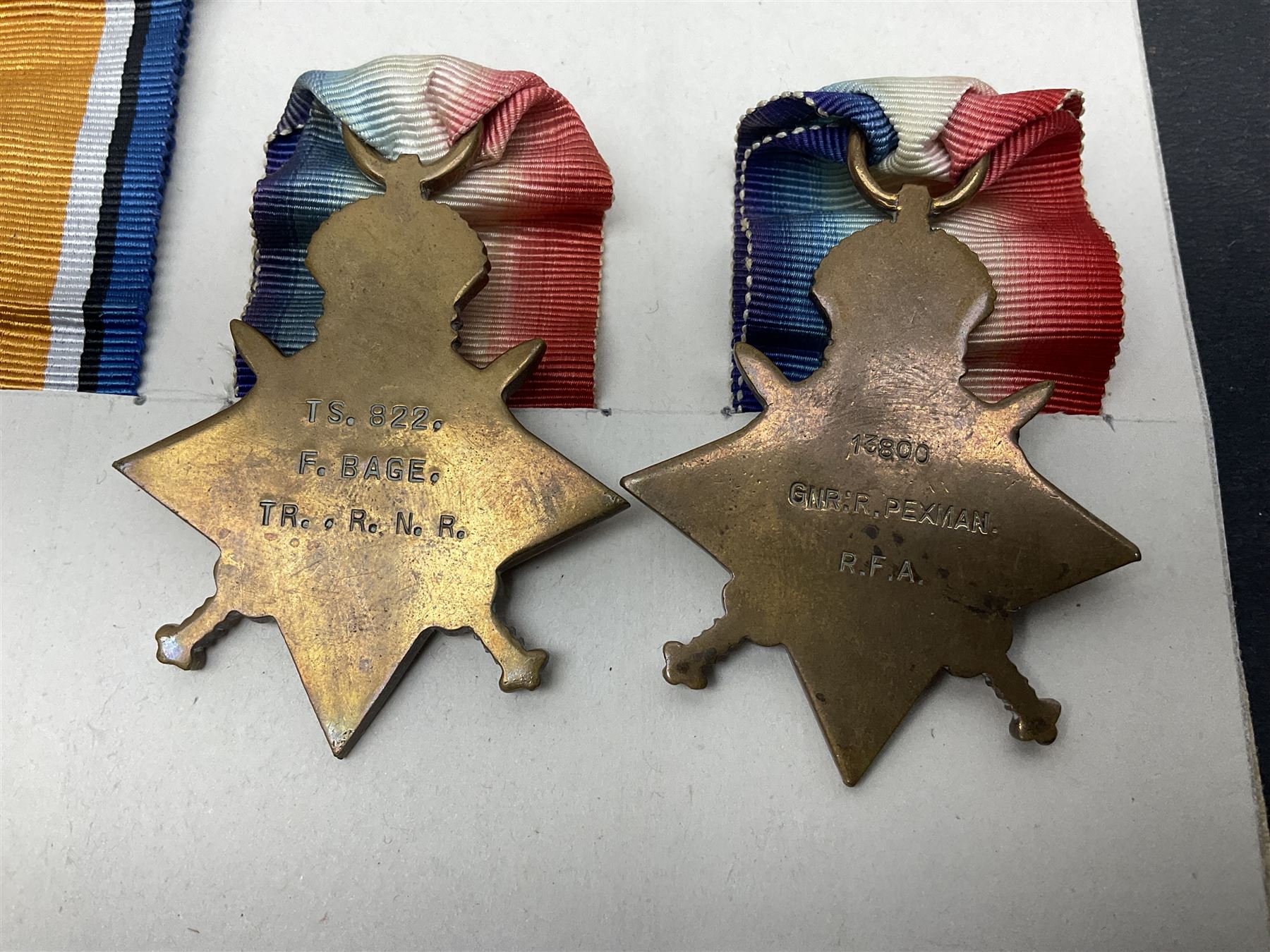 Representative display of five WWI Campaign Stars and Medals to different recipients comprising 1914 'Mons' Star to 13800 Gnr. R. Pexman R.F.A.; 1914-15 Star to TS822 F. Bage T.R. R.N.R.; British War Medal to 90461 Dvr. A.A. Cross R.A.; Mercantile Marine Medal to Patrick J. Magrath; and Victory Medal to 2657 Cpl. W.R. Kenny Norf. Yeo.; all with ribbons (5)