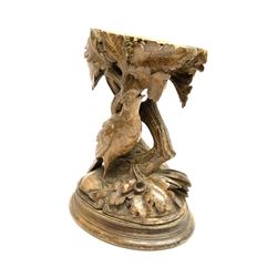 19th century Black Forrest style pedestal, carved with a bird stood before entwining trunks detailed with oak leaves and acorns, upon an oval base, H22cm