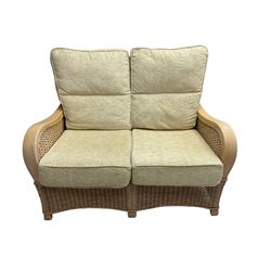 Contemporary rattan conservatory suite - two seat sofa with wicker frame and loose cushions upholstered in textured champagne fabric (W125cm H98cm); pair of matching armchairs (W72cm H98cm); rectangular glass-topped coffee table with rattan frame and undertier (W85cm D60cm H47cm); and matching square side table (W53cm H55cm)