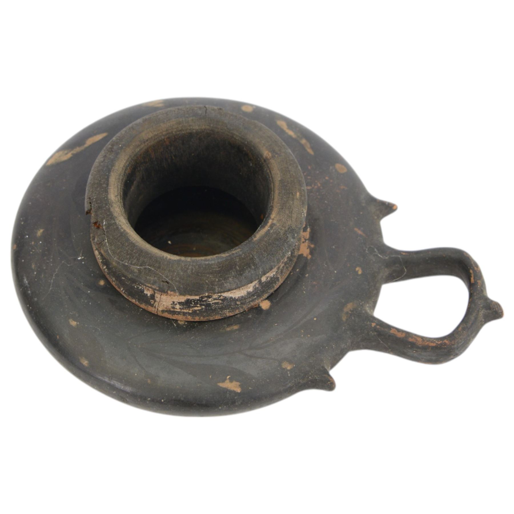 Etruscan terracotta oil lamp, with black glaze, flat loop handle and laurel leaf border, the opening with later turned wooden collar, signed to base 'repaired by one James Naysmith 1887', H7cm 