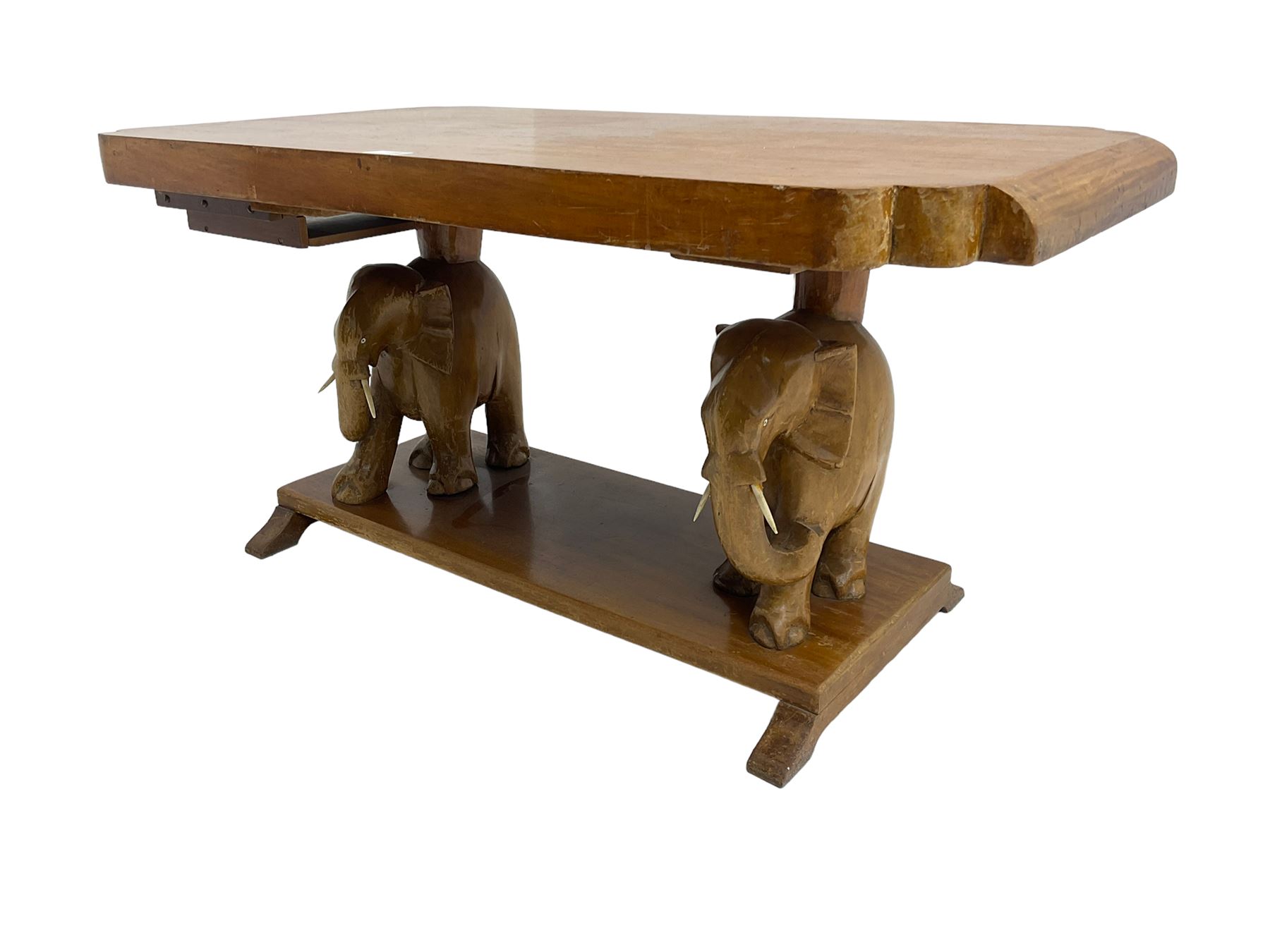 Hardwood coffee table on carved elephant figure supports, platform base on sledge feet