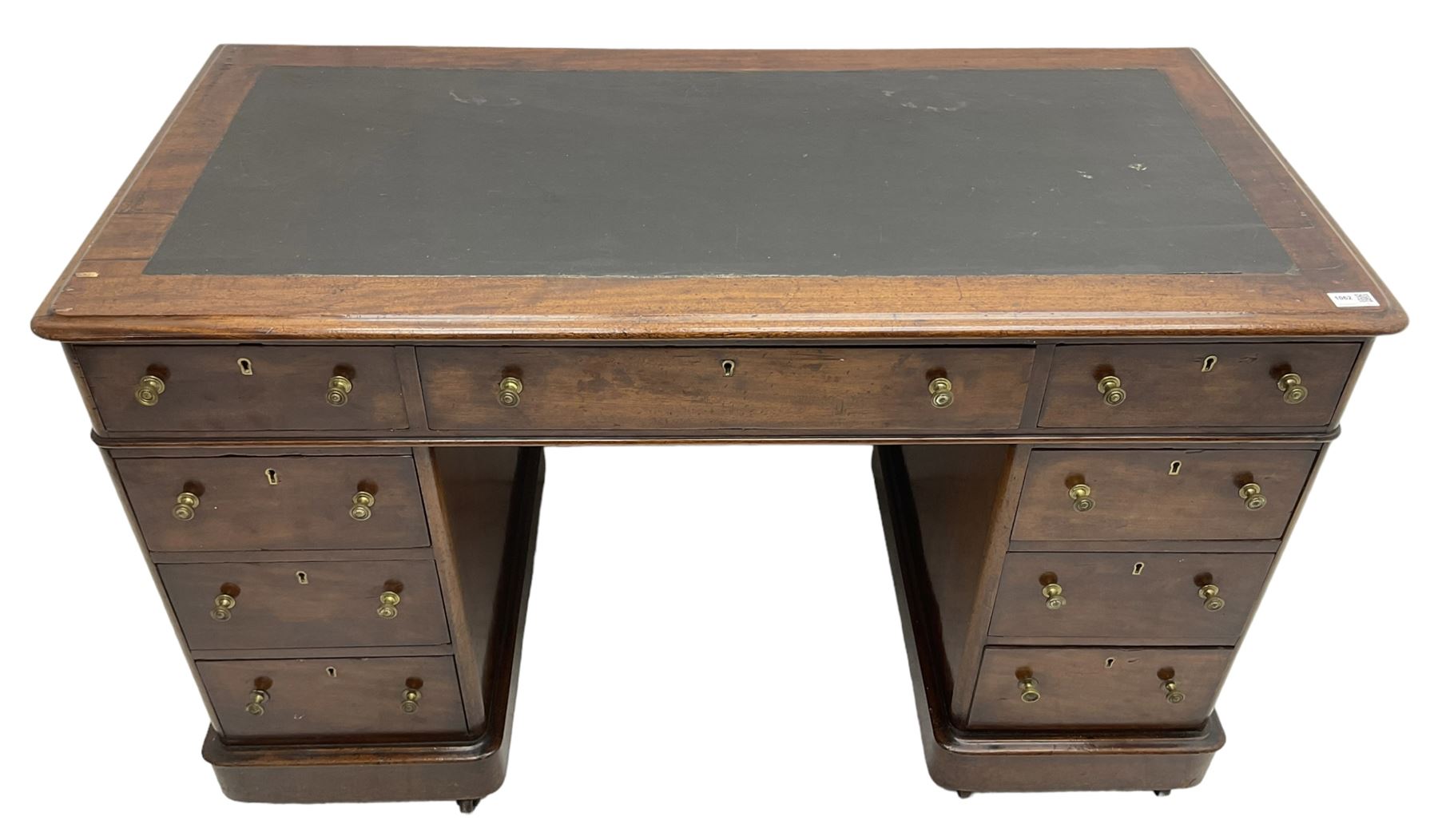 Victorian mahogany twin pedestal desk, rectangular top with inset ebonised leather writing surface, fitted with nine graduating drawers with brass pull handles, on plinth bases