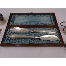 Group of silver, comprising pair of Victorian butter knives, with beaded and engraved decoration to silver handles and blades, hallmarked Martin, Hall & Co, Sheffield 1857 or 1881, in wooden silk lined fitted case, together with a 1930s two part cruet set, to include mustard pot and cover and open salt, each of circular faceted form, hallmarked Adie Brothers Ltd, Birmingham 1932, both with blue glass liners, a coffee spoon, with openwork 'Erin' terminal and two napkin rings, all hallmarked 
