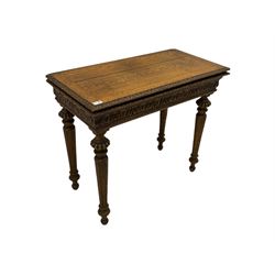 Victorian carved oak card table, fold-over top with lunette carved edge mould, the top swivels to reveal storage well, the frieze carved with scrolled foliate, on turned and fluted supports