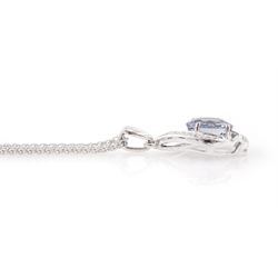 18ct white gold tanzanite and diamond pendant necklace, single oval cut light blue tanzanite of approx 3.25 carat, with diamond chip surround, on a wheat link chain necklace, both hallmarked