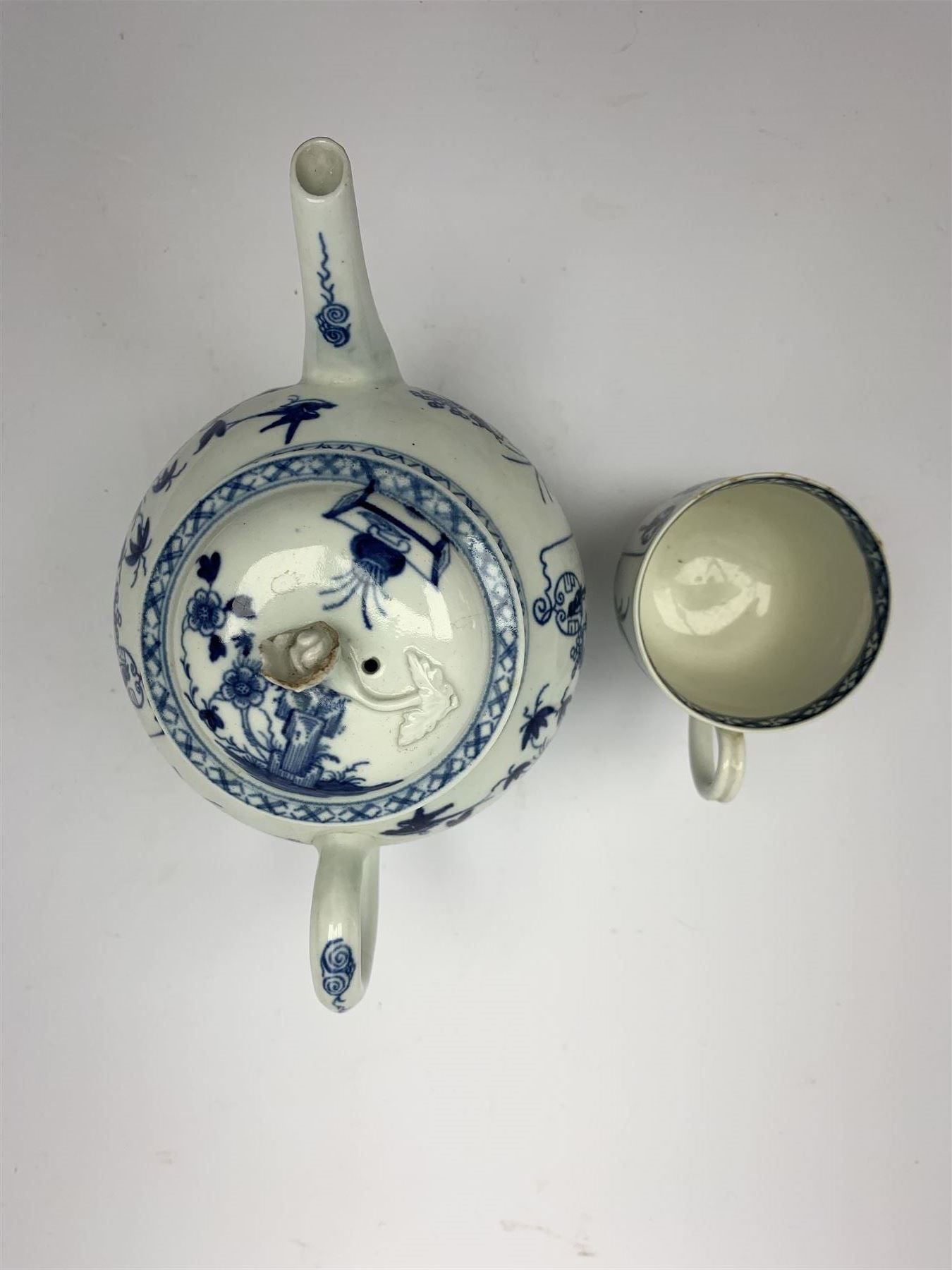 18th Century Worcester teapot, circa 1765-70, decorated in the Bird in the ring pattern, the cover with bud finial, with crescent mark beneath, H13cm, together with a Worcester coffee cup decorated in the same pattern, with crescent mark beneath, H6.5cm