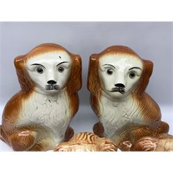 Pair of large 19th century Staffordshire dogs with glass eyes, H34cm, together with another smaller pair with glass eyes, H26.5cm, each in the form of a spaniel with russet coat (4)