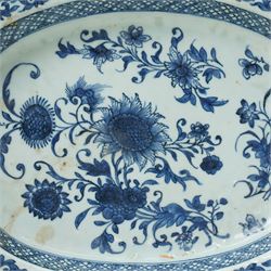 18th century Chinese oval dish shallow dish decorated with flowers in blue and white within a scroll and key pattern border W37cm and a Chinese blue and white charger D34cm (2)