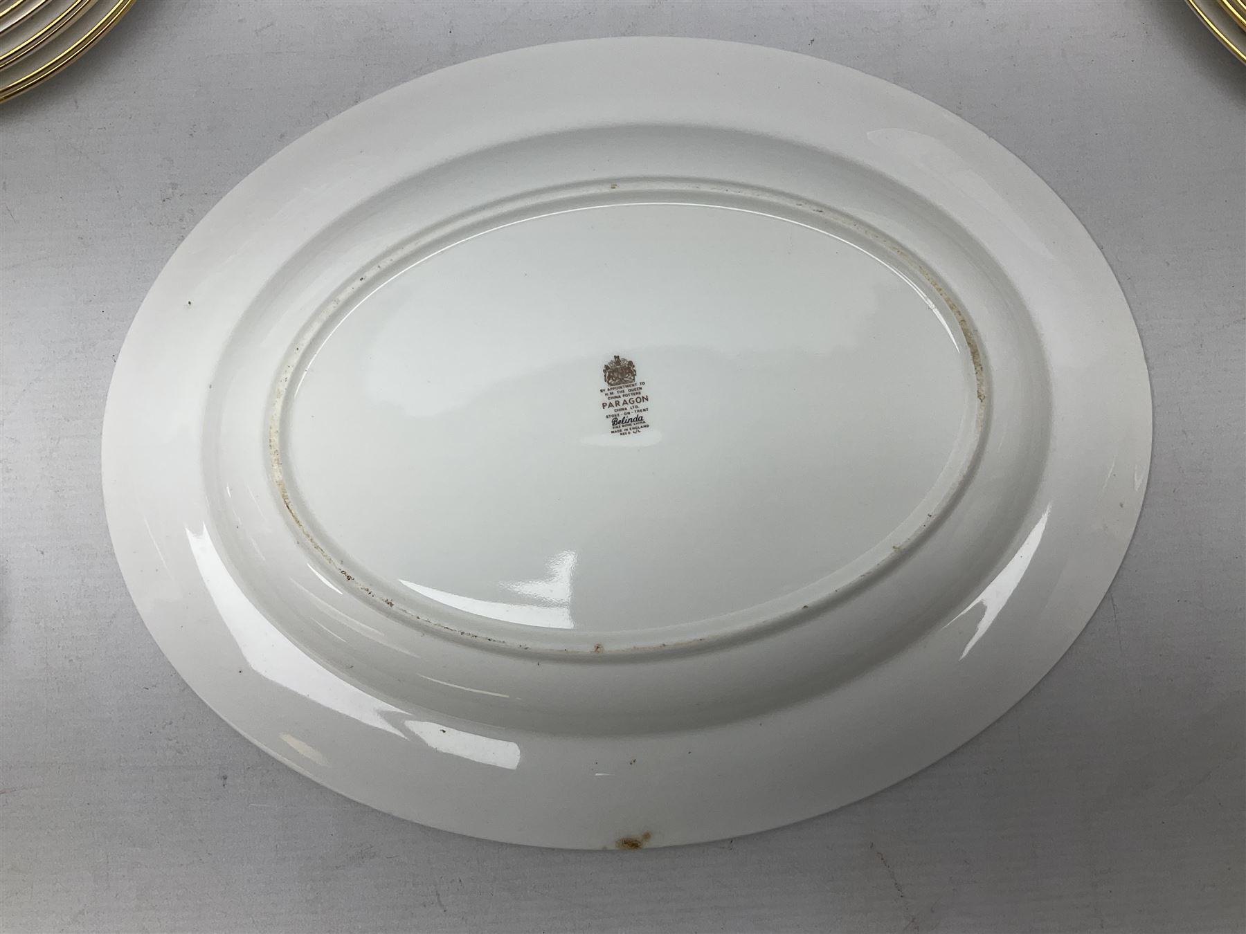 Royal Albert Paragon tea and dinner service for twelve decorated in the Belinda pattern, comprising fourteen saucers, twelve teacups, thirteen side plates, teapot, sauce boat and stand, salt and pepper shakers, two jugs, sucrier, twelve dinner plates, twelve smaller plates, two lidded tureens, twelve bowls, twelve smaller bowls, cake plate, oval plate and oval dish (100)