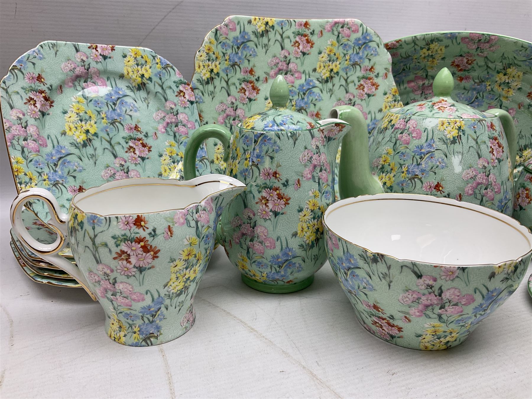Shelley Melody pattern tea service for six, to include teapot, teapot stand, hot water jug, milk jug, covered sucrier, teacups and saucers, cake plates etc (31)