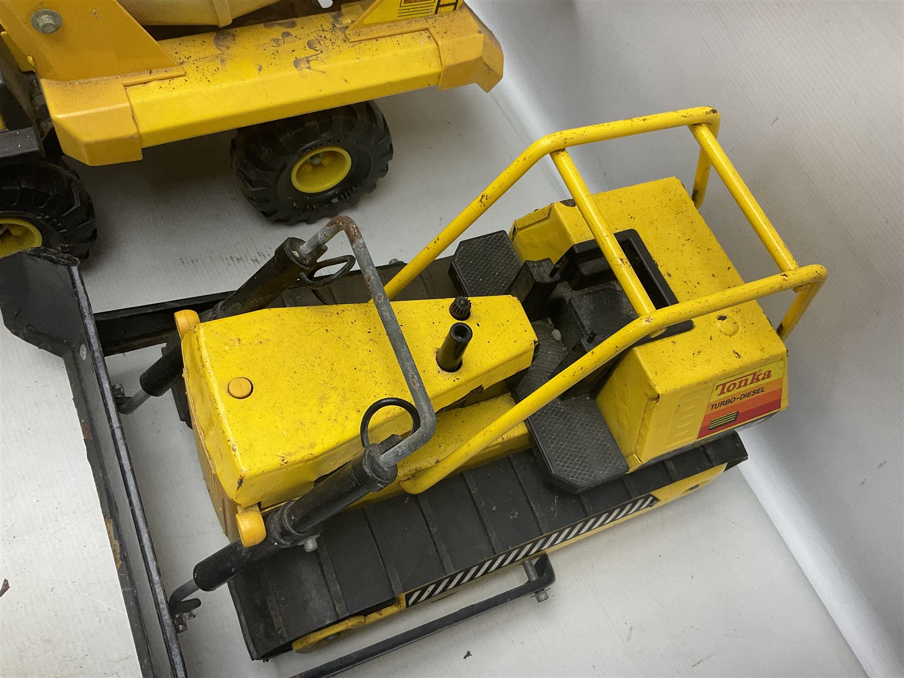 Tonka - five large scale pressed steel vehicles comprising Cement Mixer, Mobile Crane, Bulldozer and two Dumper Trucks (5)