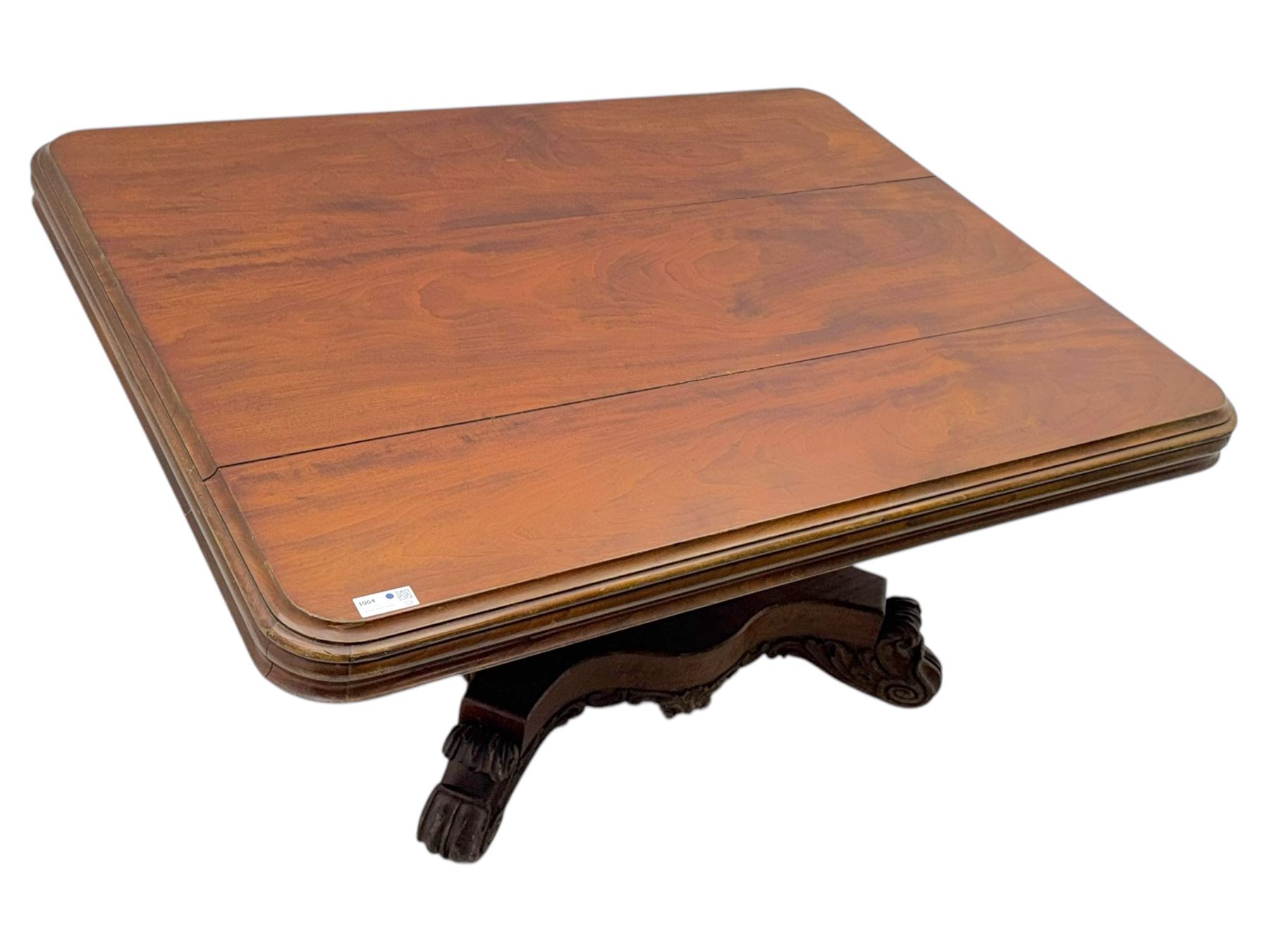 Victorian mahogany tilt-top table dining table, rounded tilt rectangular top with moulded edge, on octagonal column, raised on shaped quadriform base with bold scrolled feet