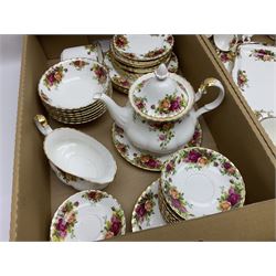 Royal Albert Country Roses pattern part tea and dinner service, including Teapot, two milk jugs, open sucrier, eight teacups and saucers, six coffee cups and saucers, eight dinner plates, salt and pepper etc  