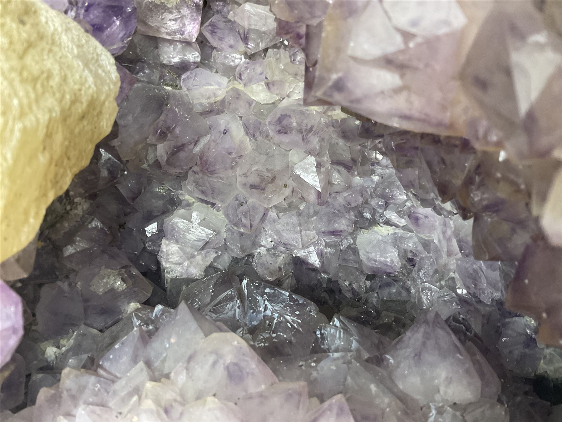 Amethyst crystal ‘cathedral’ geode, free standing with flat base and prepared outer surface, with well-defined crystals of various sizes within the cavern, H39, L32cm
