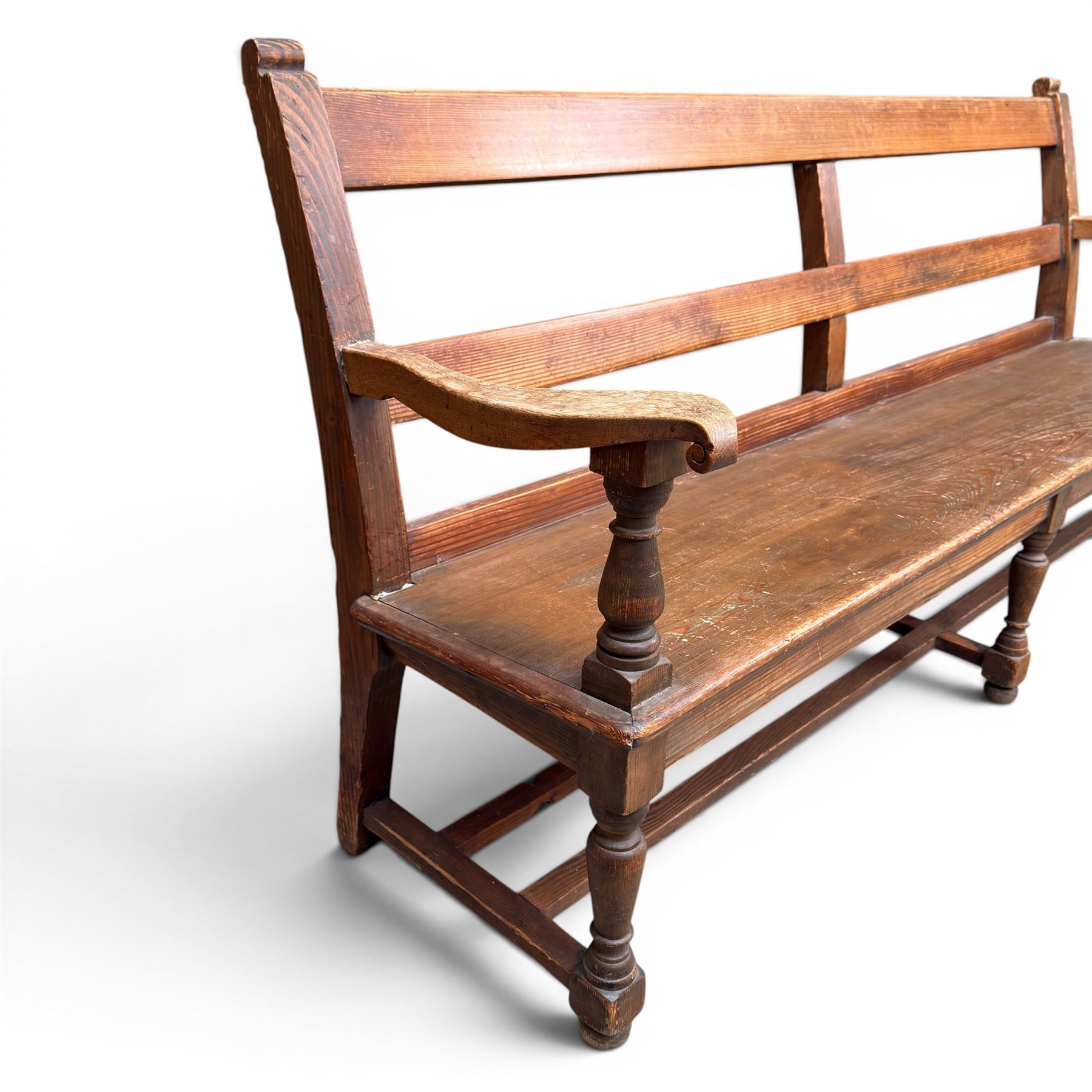 Early 20th century pine and oak bench seat, stained pine rail back frame with shaped oak arms
