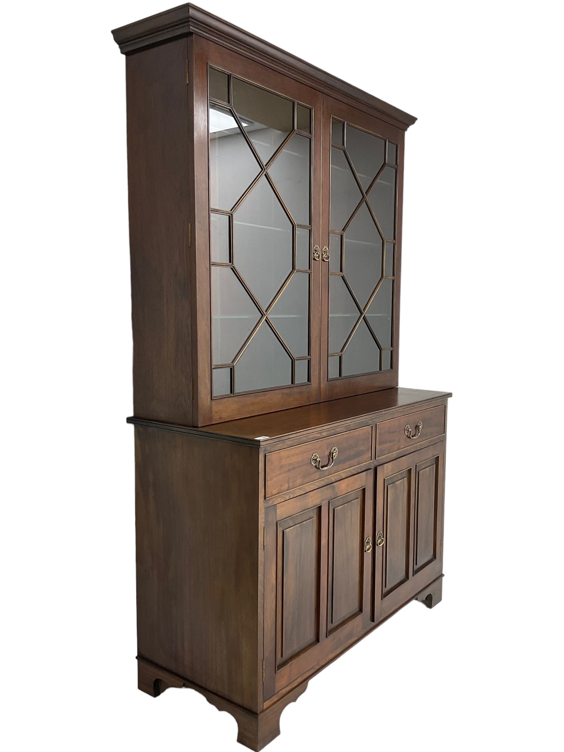 Acorn Industries - Georgian design mahogany bookcase on cupboard, fitted with two astragal glazed doors enclosing three glass shelves, base with two cock-beaded drawers over two panelled cupboards, inlaid with acorn signature, by Alan Grainger, Brandsby