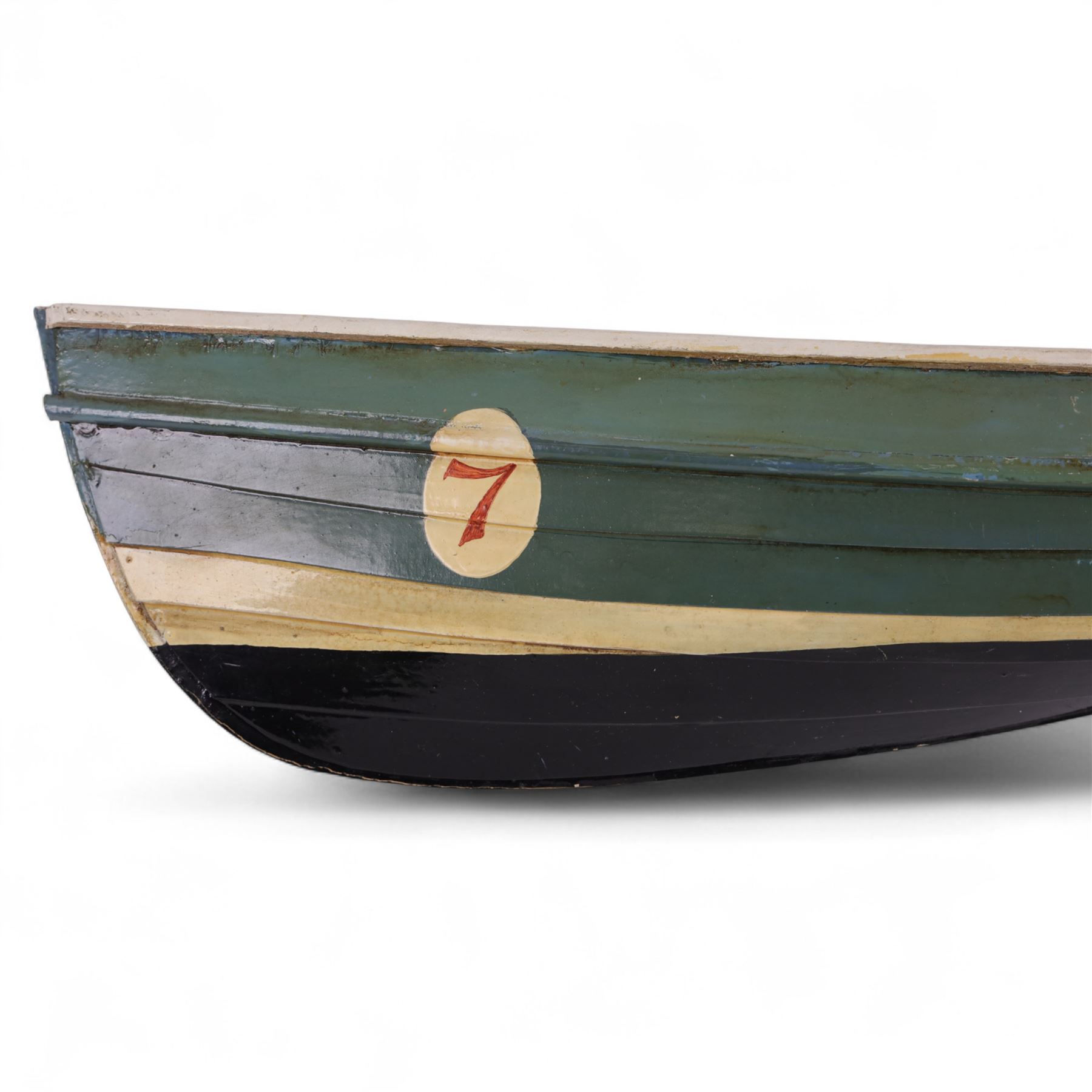 Two wooden fishing coble models, comprising SE31, with rudder, painted in blue, white and red and SSS.33 'Alice', painted in green, black and yellow, largest H16cm, L70cm
