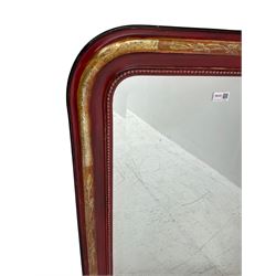 Arched top wall mirror with bevelled plate, in moulded red painted and gilt frame