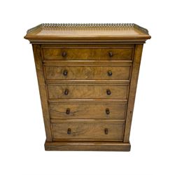 Johnstone Jeanes & Co - Late 19th century walnut Wellington chest, rectangular top with raised cast brass gallery of interlocking foliate design, over five graduating drawers with moulded facias and turned roundel handles, fitted with hinged lock to the right, on skirted base