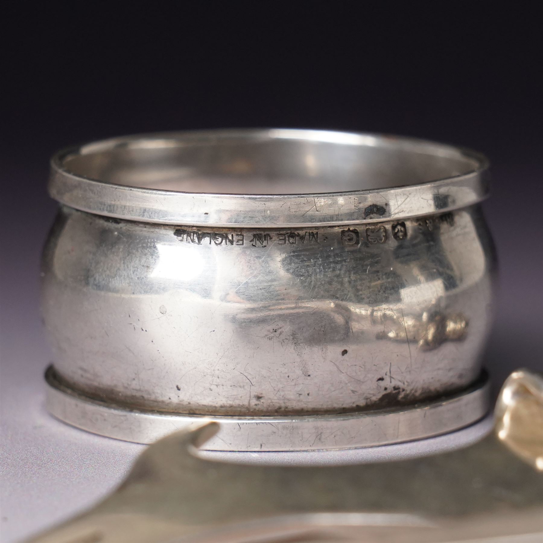 Assorted silver including two 19th century condiment spoons, coffee spoon, napkin ring, knife, two silver brooches and a charm 