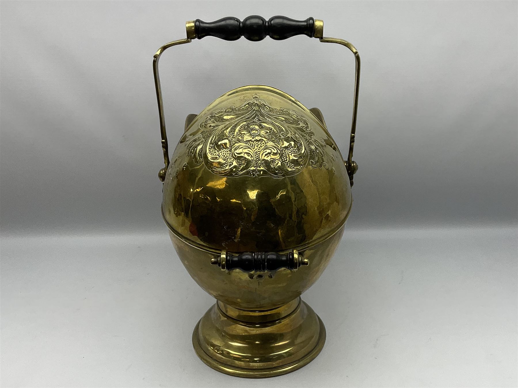 Victorian brass coal scuttle, of helmet form with turned ebonised handles, H48cm