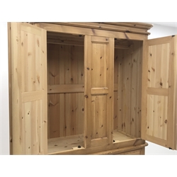 Waxed pine wardrobe enclosed by two panelled doors on chest fitted with three small and two long drawers, turned feet, W125cm, H202cm, D57cm