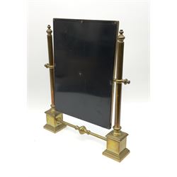 A brass table top swing mirror, upon stepped supports with stretcher, H41.4cm L34.5cm.