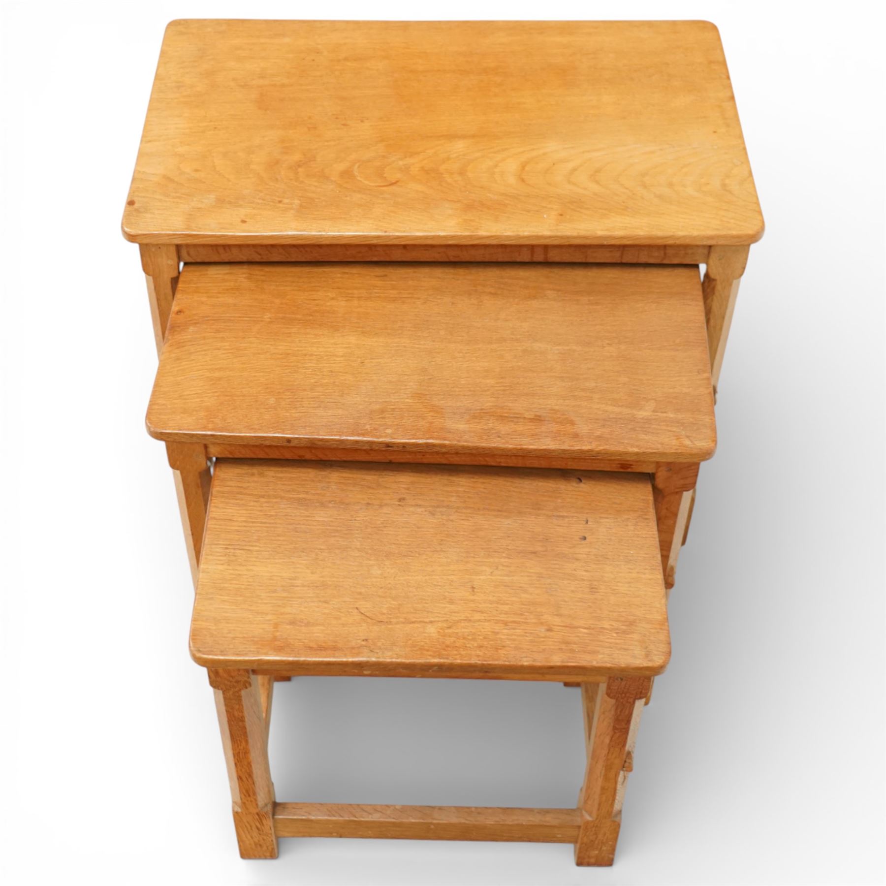 Mouseman - oak nest of three tables, raised on octagonal supports, with carved mouse signature, by the workshop of Robert Thompson of Kilburn