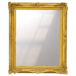 French style gilt composition wall mirror, the rectangular plate within a swept frame moul...