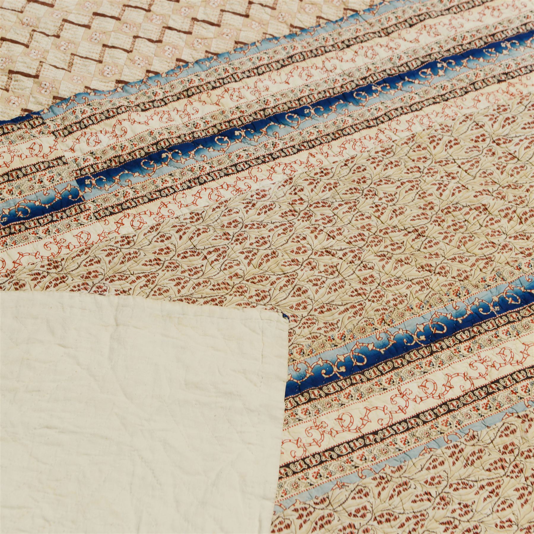 Handmade large patchwork quilt bedspread made up of individual squares of multi-coloured cottons and backed in a cream cotton, 243cm x 284cm 