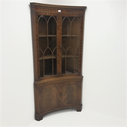 20th century figured mahogany double corner cabinet, dentil frieze above two doors enclosing two shelves above two cupboard doors, shaped bracket supports, W92cm, H189cm, D50cm