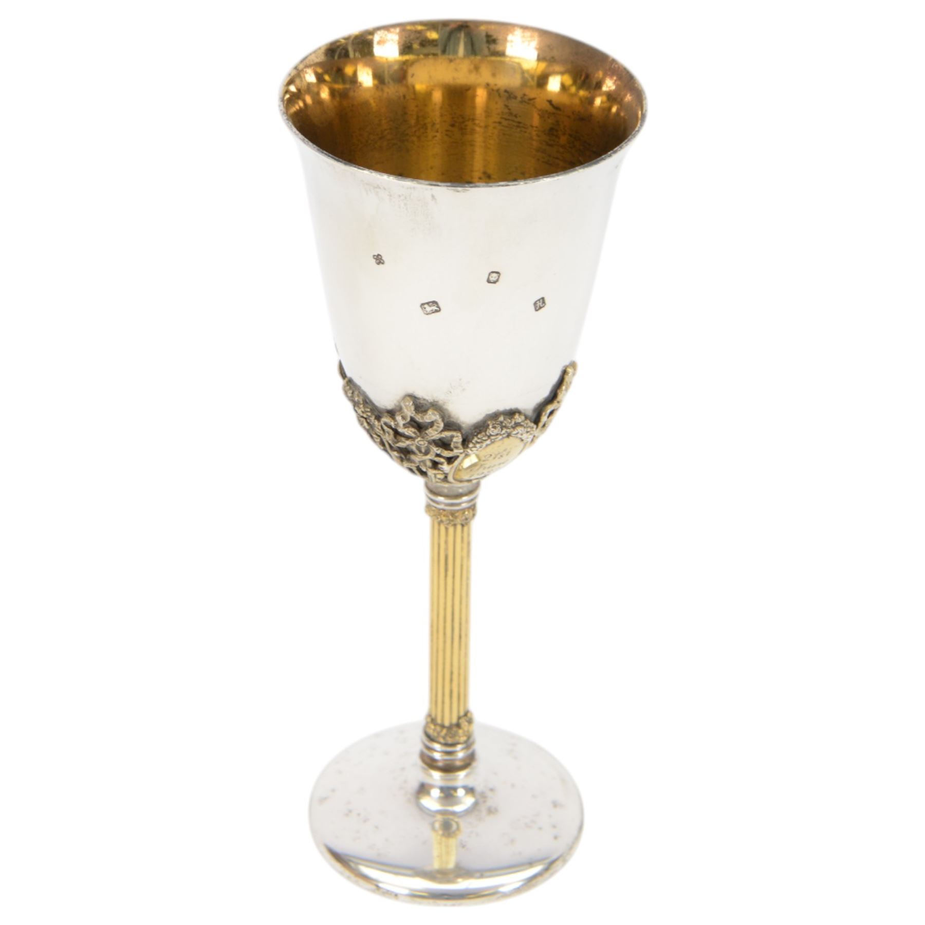 Late 20th century silver goblet, commemorating the birth of HRH Prince William of Wales 21st June 1982, the goblet of plain form, with parcel gilt daffodils and ribbons atop a parcel gilt column stem upon a circular foot, hallmarked St James House Company, London 1982, H19.5cm