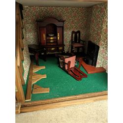 Two storey wooden dolls house with sliding panels, with a small collection of dolls house furniture, H57cm, W48cm
