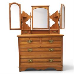 Edwardian satinwood dressing chest, rectangular moulded top over two short and two long drawers with brass drop handles, raised mirror back with arched central plate flanked by hinged side mirrors, small fitted trinket drawers and shaped pierced side supports with turned uprights