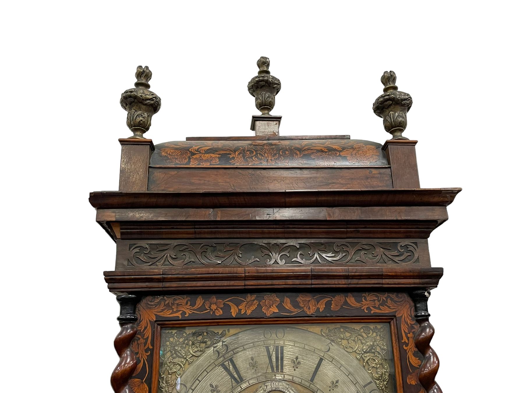 William & Mary floral marquetry 8-day longcase clock c 1700, later mid-18th century four pillar rack striking movement with a square brass dial and subsidiary seconds dial, ringed winding holes and calendar aperture to the matted dial centre, with London cherub head cast spandrels and (later) fretted steel hands, silvered Roman numeral chapter ring with stylised fleur di Lis half hour makers, narrow Arabic five-minutes, minute track and inner quarter hour track, signed Thomas Horlock, Hammersmith, 
case with box upstand to the domed floral marquetry decorated caddy with three brass flame finials, above a moulded cornice and fretwork frieze,  inlaid hood door with attached barley twist pillars to the front above an inlaid convex moulding, full length D moulded trunk door with a circular lenticle inlaid with floral and foliage panels inhabited with birds, on a conforming marquetry plinth with applied double skirting. Thomas Horlock is recorded as a Whitesmith & Clockmaker of Hammersmith, Middlesex.
A copy of Thomas Horlock's will dated the 15th June 1757 is held at The National  Archives Kew.