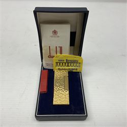 Dunhill gold plated lighter with textured bark effect decoration, in fitted case