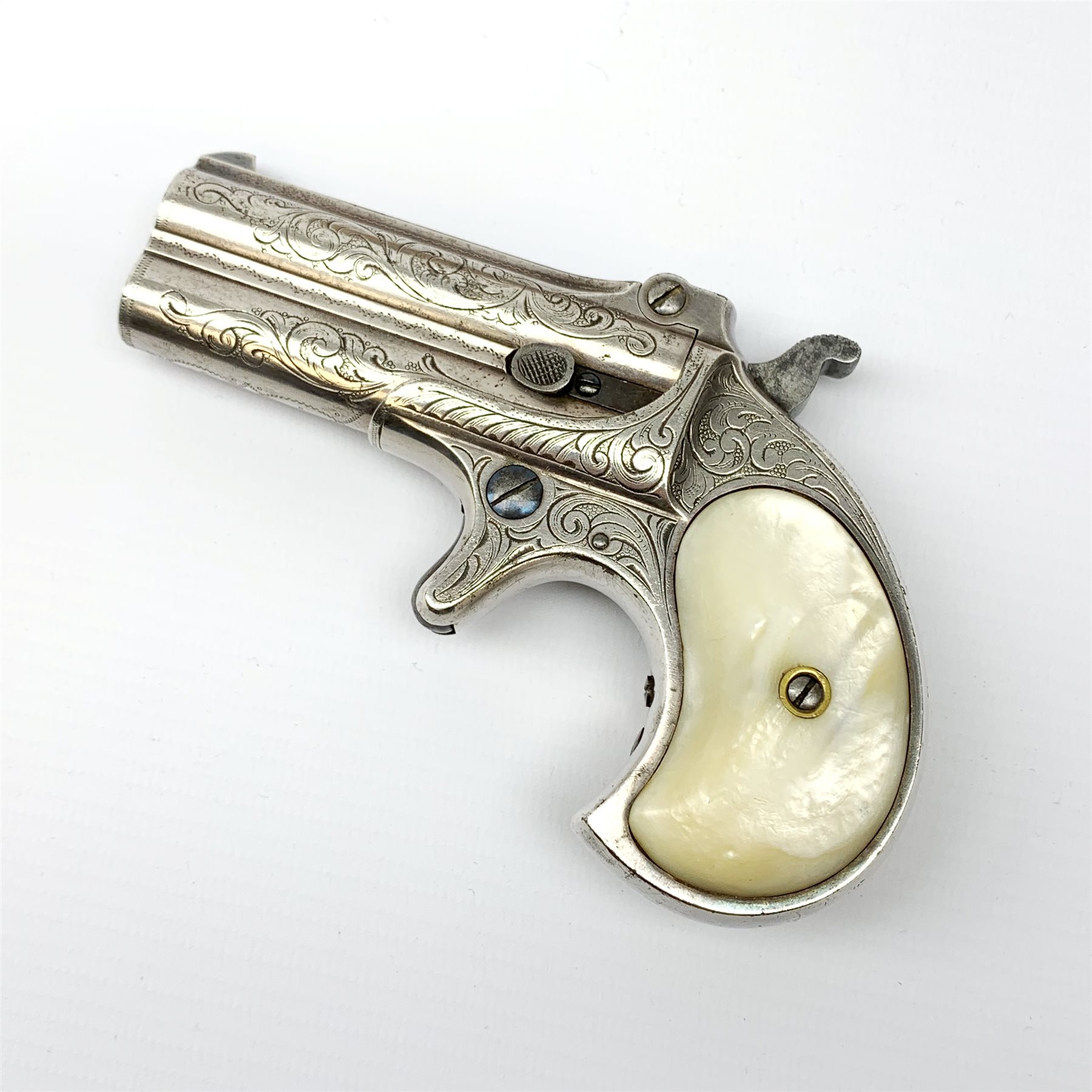 Factory engraved Remington .41 calibre double barrel over and under Derringer, the top of the barrels inscribed 'E. Remington & Sons Ilion. N.Y. Elliot's Patent Dec 12th 1865', with mother-of-pearl split grip, serial no.2695, L13cm overall; with receipt of purchase from Pete Holder dated 08/06/2008; reputedly from the Raymond Kendal collection (former Director of Interpol); with box of  dummy cartridges