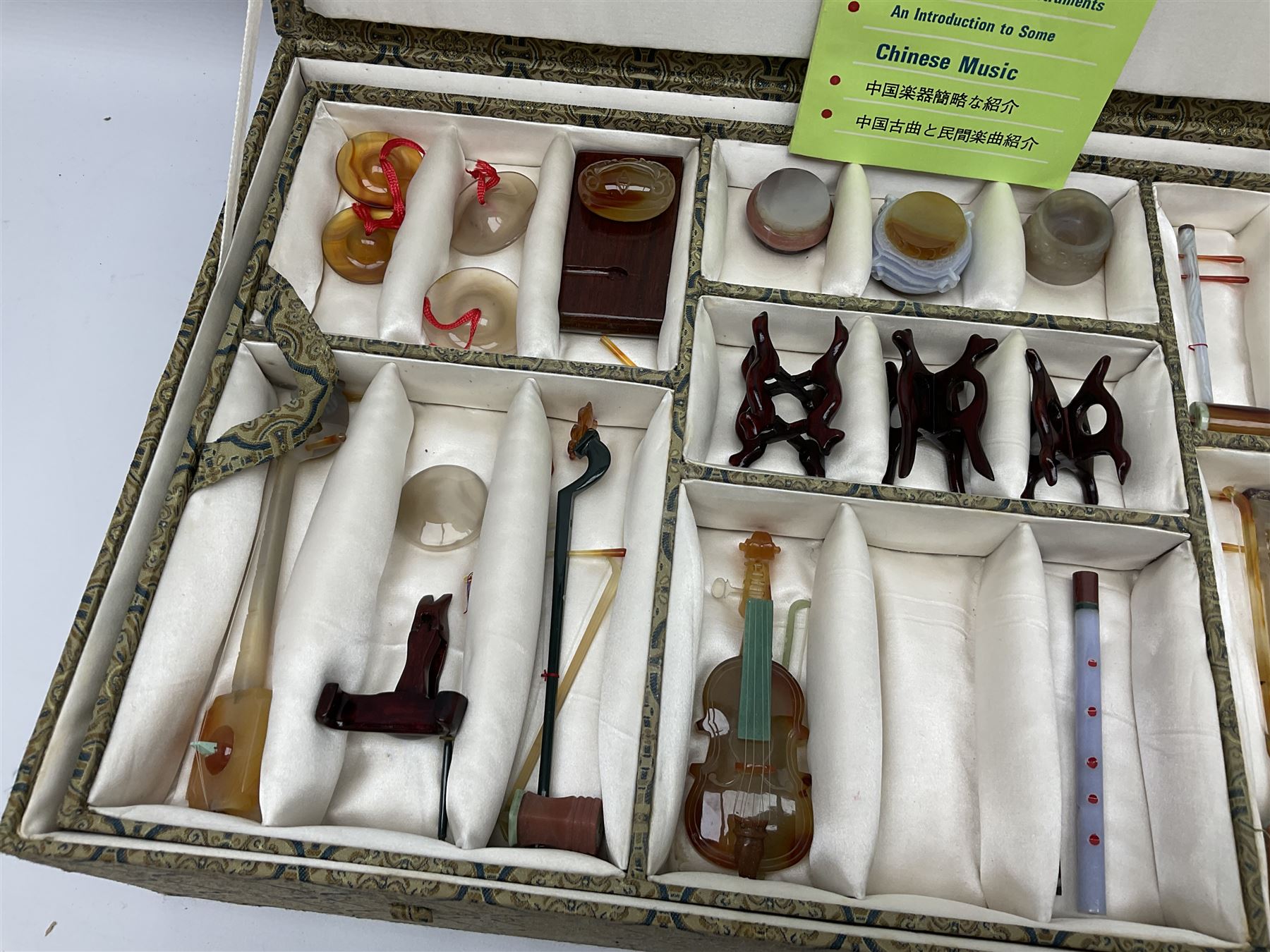 Chinese boxed collection of miniature polished hardstone musical instruments with hardwood stands