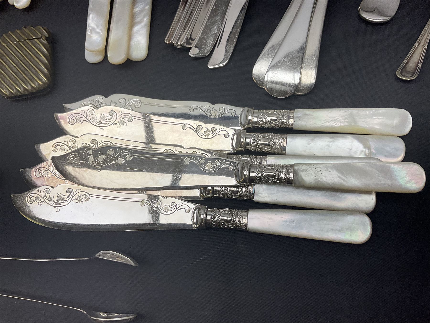Mother of Pearl handled cutlery, with silver ferrules, comprising six fish knives and forks and six fruit knives and forks, the ferrules hallmarked Yates Brothers, Sheffield 1905, together with silver plated Edwardian three piece tea service and other flatware 