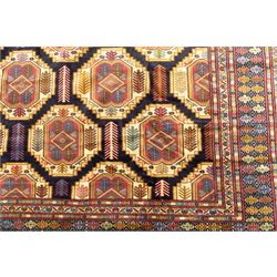 Central Asian Turkmen, main field with octagonal guls enclosing hooked diamond motifs in shades of madder gold, ivory, and indigo set against a dark ground within multiple polychrome borders of geometric devices and stepped motifs 