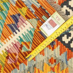 Afghan Chobi flatweave kilim runner, with a repeating stepped diamond medallion design in ivory, green, rust, teal, purple, indigo, and framed by chevron and geometric borders