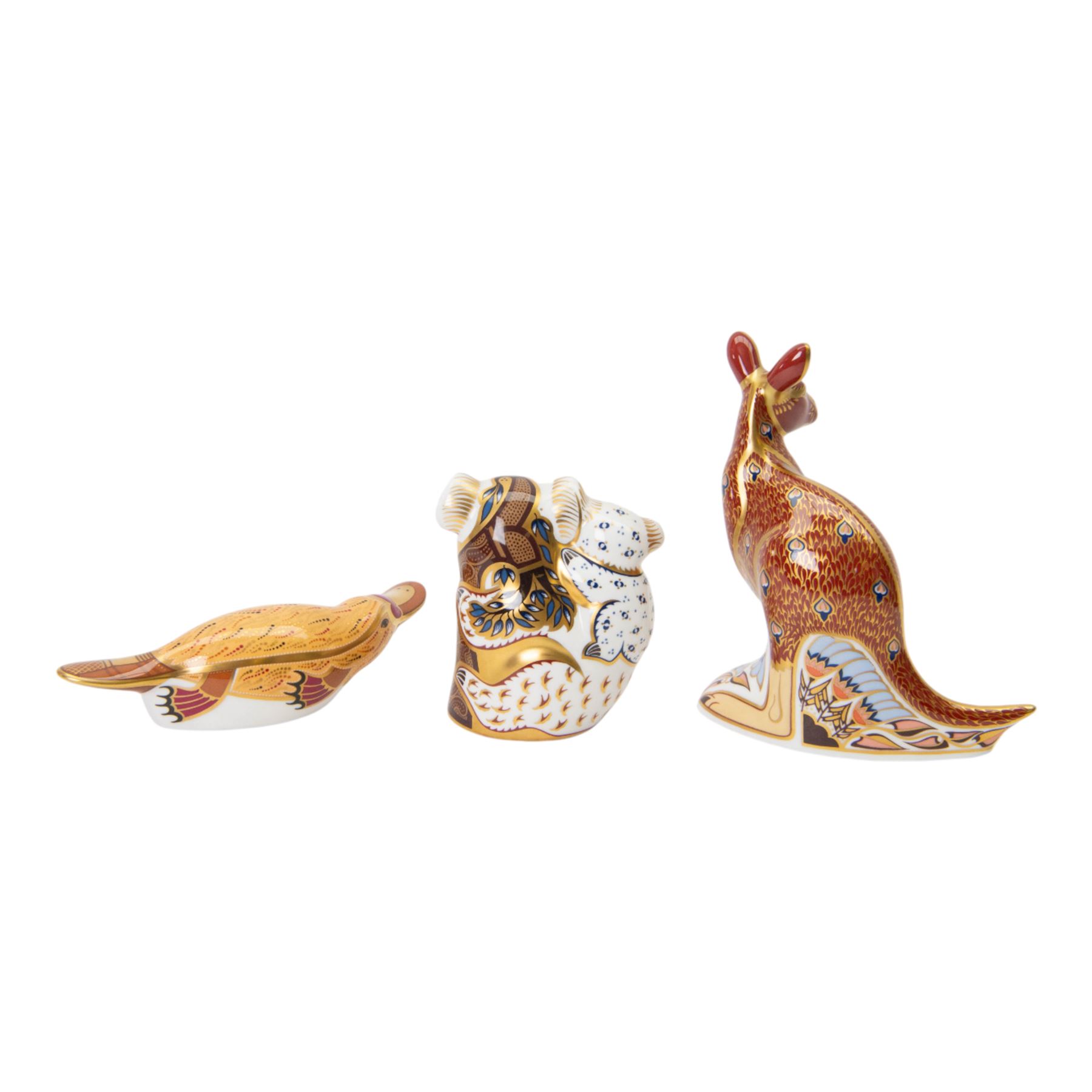Set of three Royal Crown Derby paperweights, The Australian Collection, Kangaroo and Joey, Duck-billed Platypus, and Koala and Baby, part of a gold signature edition with limited availability until the end of 2000, each with gold stoppers, Kangaroo and Joey H15cm