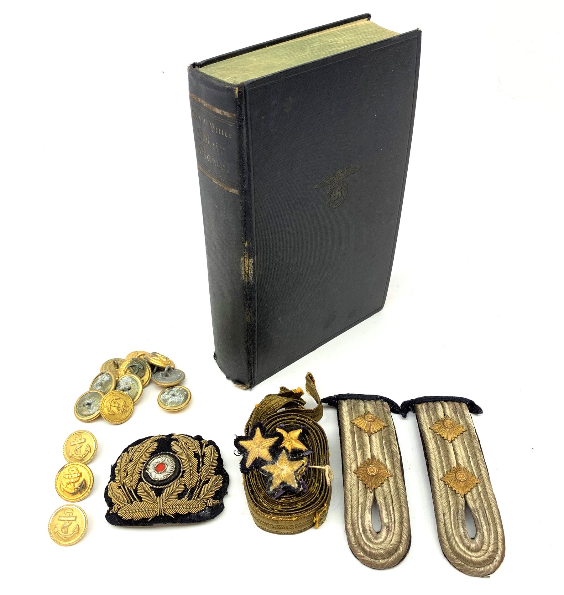WW2 Kreigsmarine uniform accessories from prisoner of war U-boat Kapitanleutnant Gunther Lorenz comprising cap badge, pair of epaulettes, thirteen buttons marked 1940 and roll of rank braiding and stars; together with copy of Adolf Hitler's Mein Kampf. 1936 published by Zentralverlag Der NSDAP Munchen with German text.
